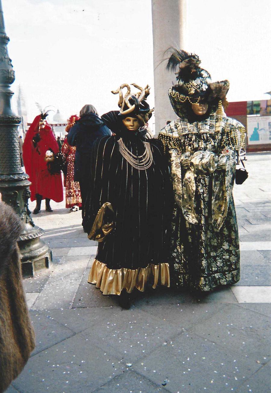 Vibrant celebration at the Venice Carnival with attendees in elaborate costumes and masks