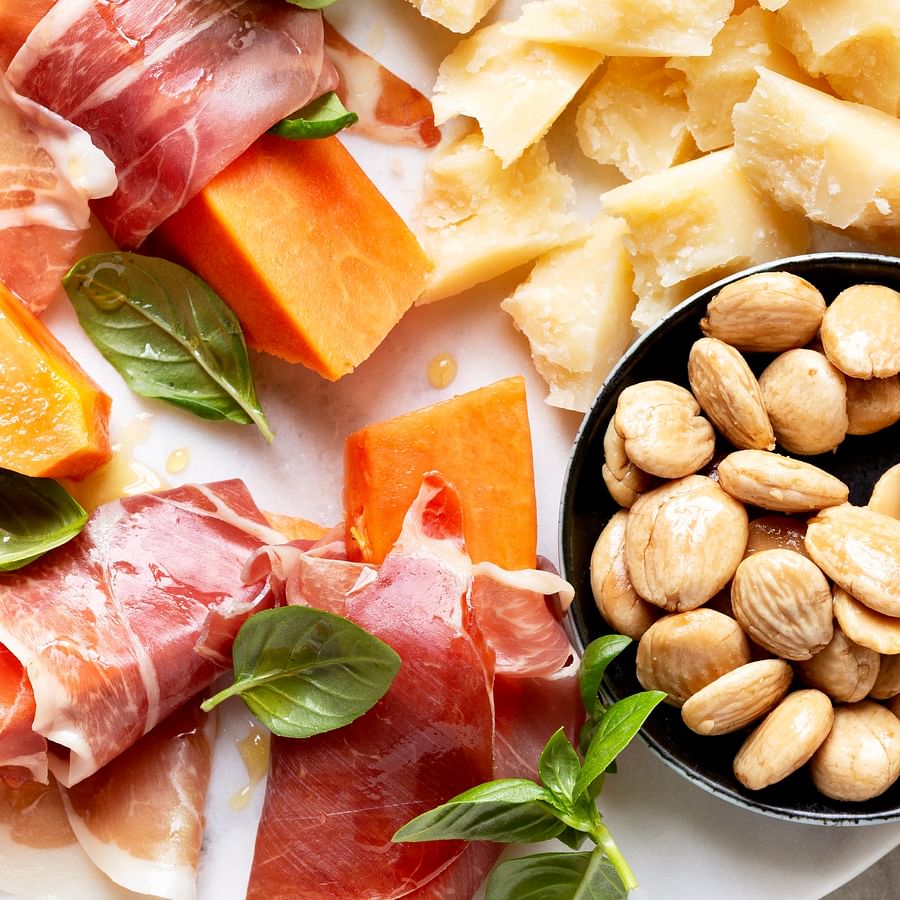 Delicious Parma ham and Parmigiano Reggiano cheese served on a plate